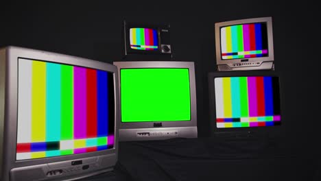 pila de televisión vintage retro encendiendo pantallas verdes. usted puede reemplazar la pantalla verde con las imágenes
