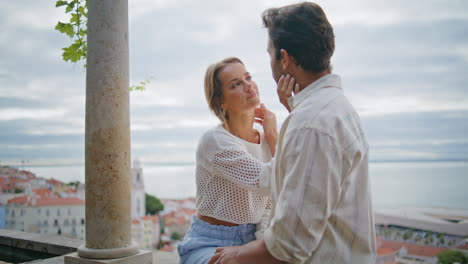 love pair caressing faces at seascape date closeup. man touching enamoured woman