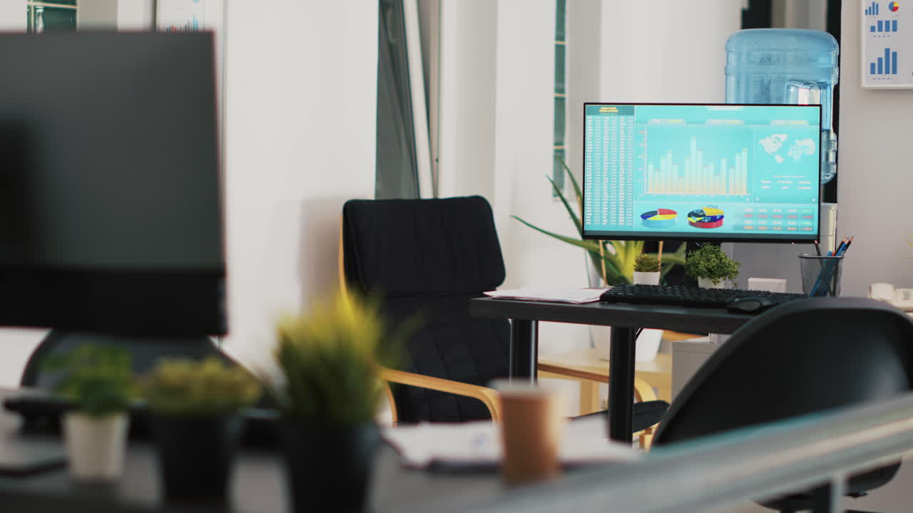 Computer screen in company workspace showing trading platform and pie charts