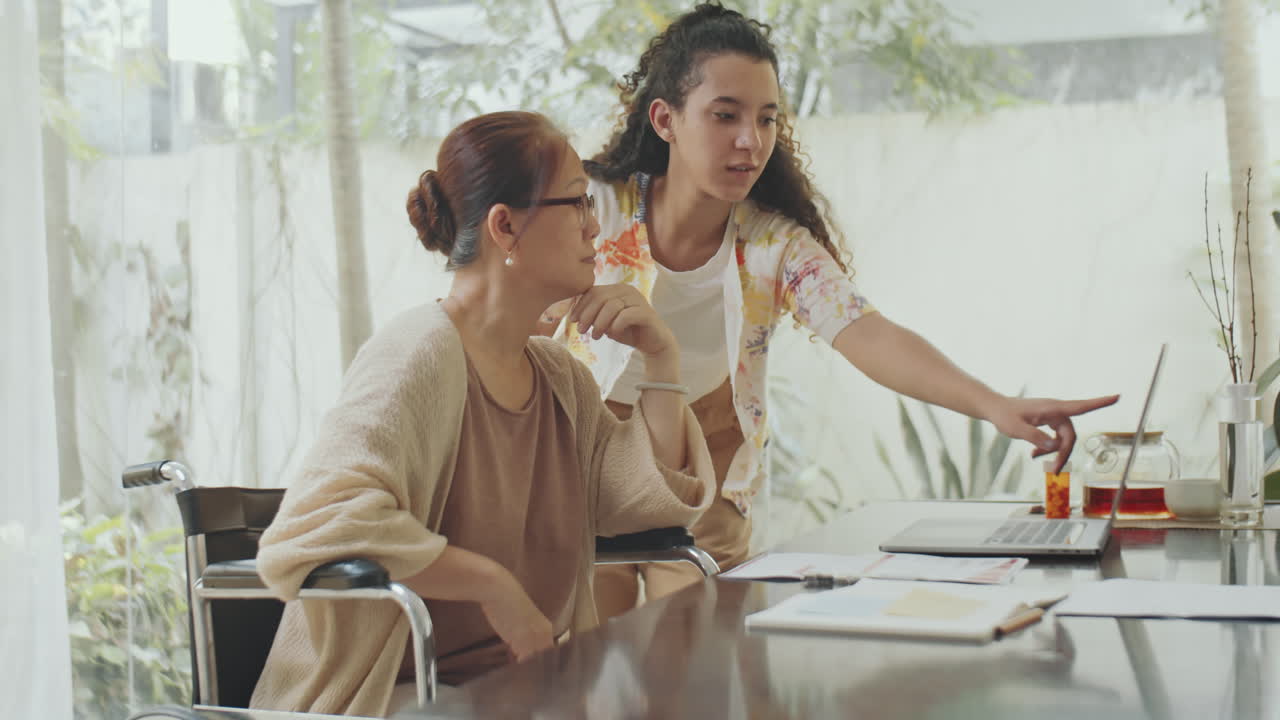 Young Woman Assisting Senior Woman at Home