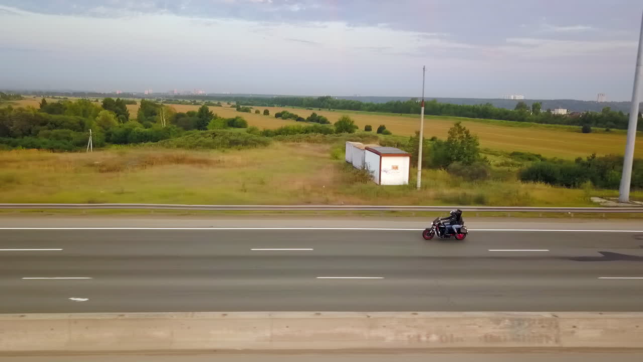 Motorcycle on a highway in a rural landscape