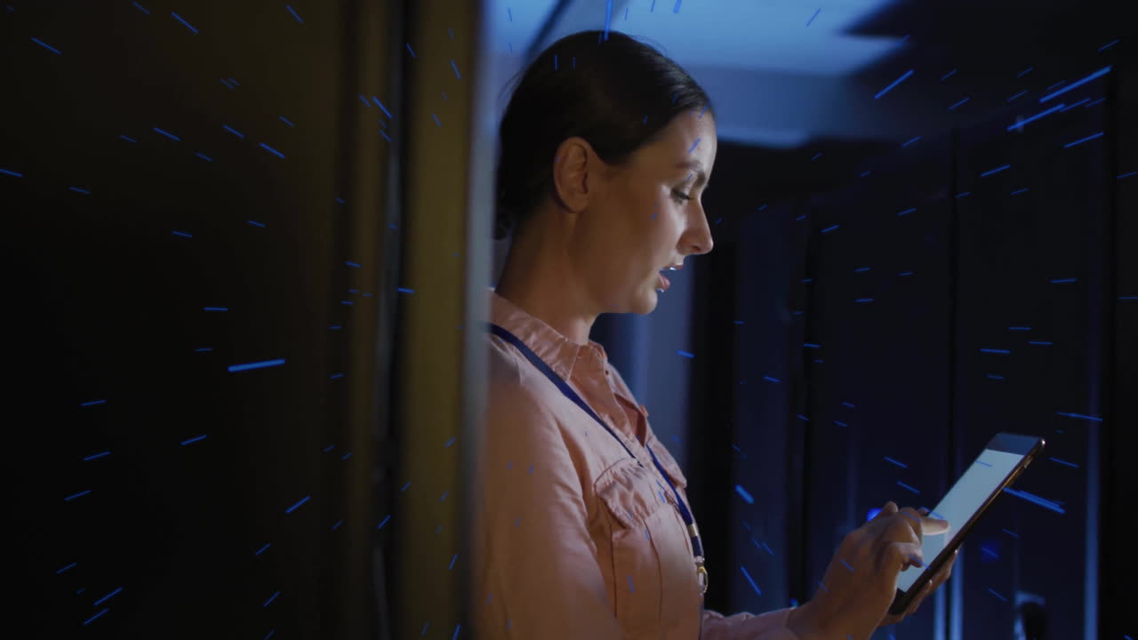 Woman using tablet in server room with digital data animation overlay