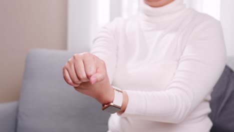 woman performing self-massage on her right arm wrist