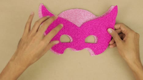 measuring, layering and join pink diamond foam with hands, carnival mask