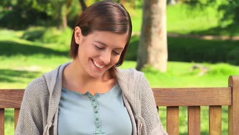 young woman reading a book outside