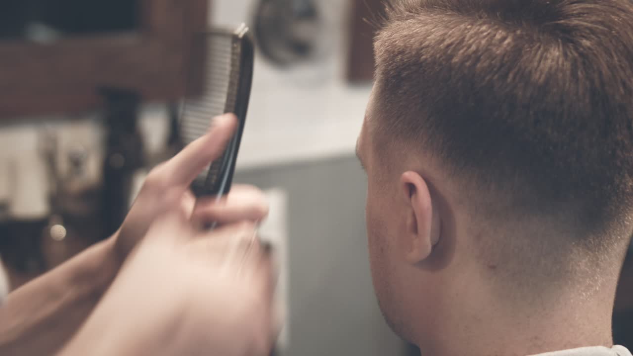 corte de pelo masculino. peinado masculino. barbero cortando el cabello con un cortador de cabello