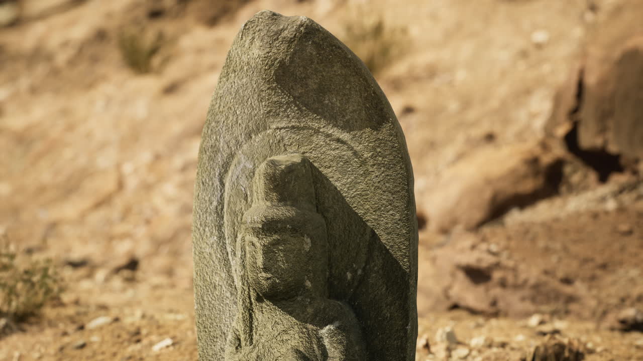 Historic stone sculpture located in an arid landscape during daylight hours