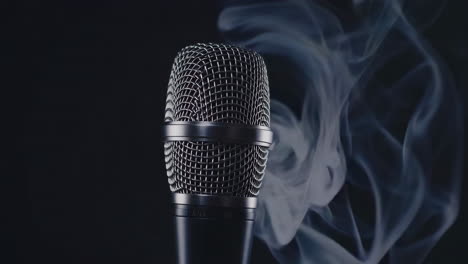 close-up of a microphone with swirling smoke on a dark background