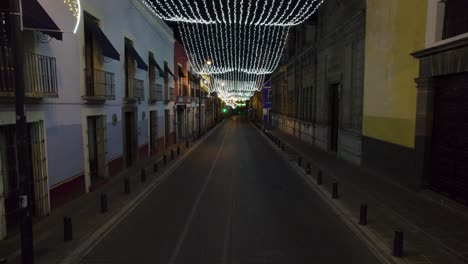 drone video of the christmas decorations and lights in a colonial architecture streets