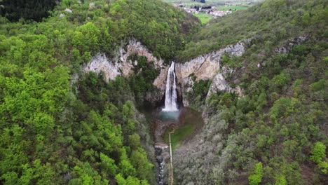 An-areal-shoot-of-a-beautiful-waterfall-in-Bosnia-and-Herzegovina,-with-a-slightly-tilt-in-the-camera