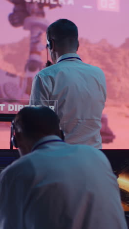 vertical shot of employees using computers to control mars research rover remotely during work in office of space agency