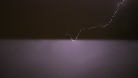 Streak-of-lightning-flashes-in-the-night-sky-in-Madrid,-Spain