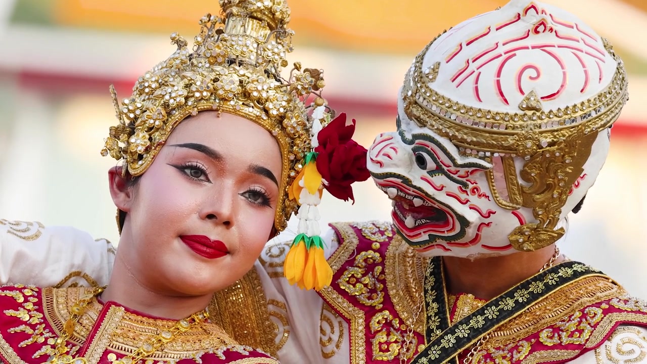 Nærbillede af traditionelle thailandske Khon-dansere i udsmykkede kostumer, der opfører et klassisk maskeret drama