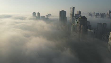 fog in uae: aerial view of fog over sharjah's khalid lake, sharjah skyline covered in the winter morning fog, united arab emirates, 4k drone footage