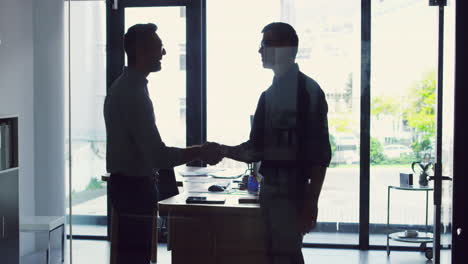 two-businessmen-shaking-hands-while-standing