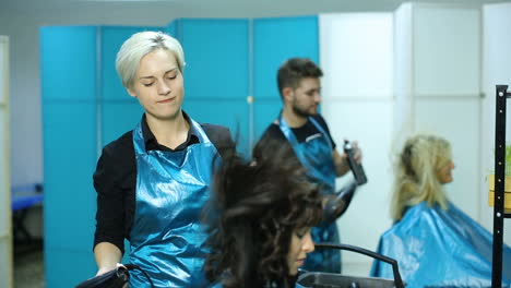 professional hairdresser cutting hair. young woman and hairdresser making styling hair at beaty salon