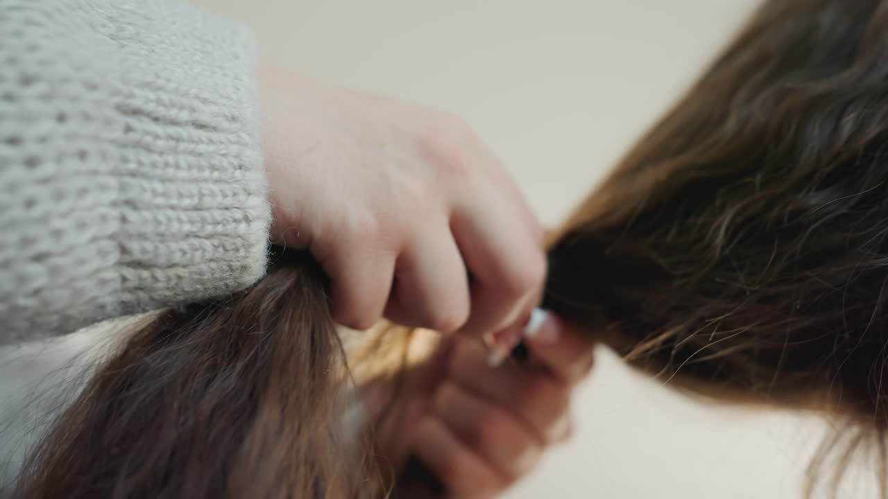 Focus On Fingers Creating Braided Hairstyle, Detailed Image Of Hands Sectioning And Tying Hair Meticulously, Intimate View Capturing Fingers Carefully Styling And Braiding Long Brown Hair At Home