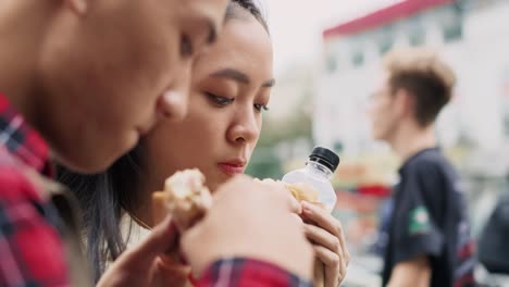 handheld view of young couple enjoying take out food