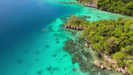 drone rising above coral reef on hidden island in fiji where snorkelers explore