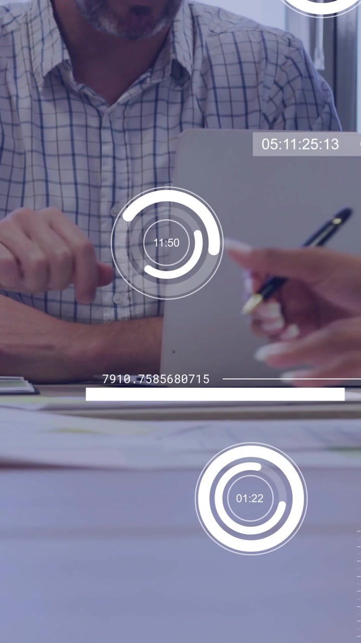 Vertical video: Man at laptop watching peer writing for review and causing business charts updating