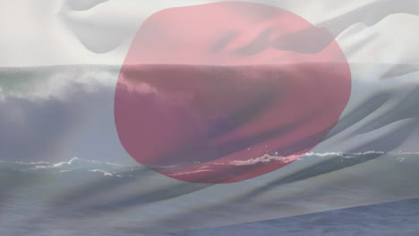 Digital composition of japan flag waving against aerial view of waves in the sea