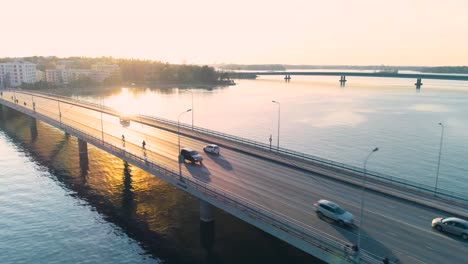 tracking aerial shot of a bridge in helsinki during sunset