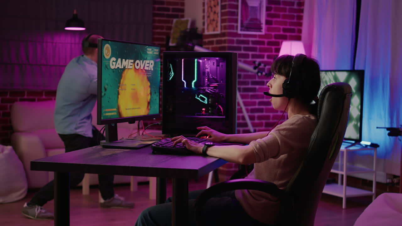 Gamer girl shocked after losing action space simulation game while boyfriend is playing virtual reality first person shooter