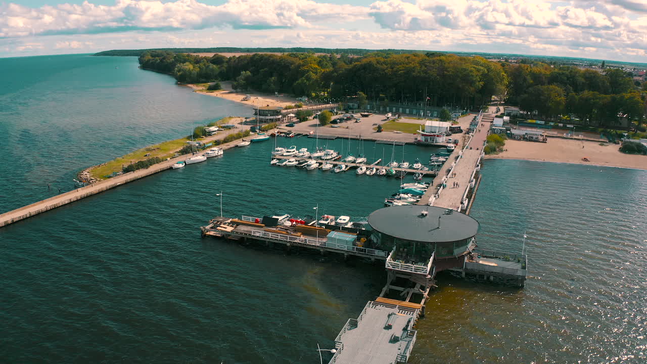 Aerial shot of drone flying above Puck's bay in Poland with pier in the background