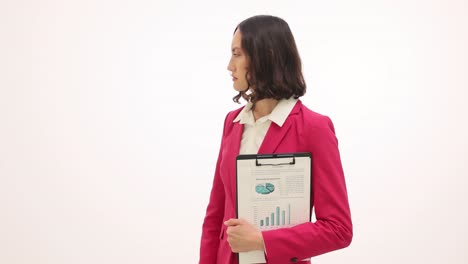 professional businesswoman in pink blazer holding a clipboard
