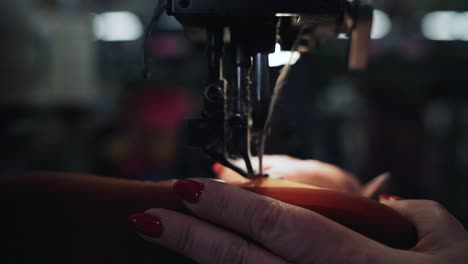 worker sewing the sole of a shoe slow motion