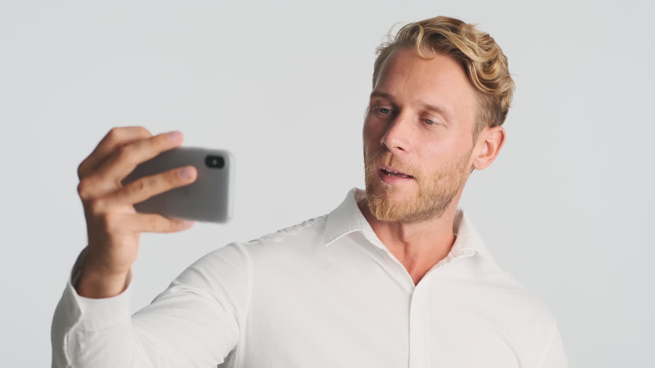 Young businessman taking picture of himself