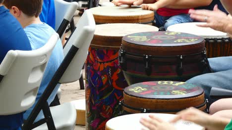 Kids-and-Adults-play-hand-drums-in-a-drum-circle-outside