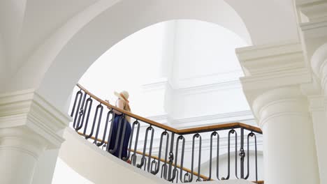 Woman-walking-up-the-stairs-in-Jelgava-Baroque-style-palace