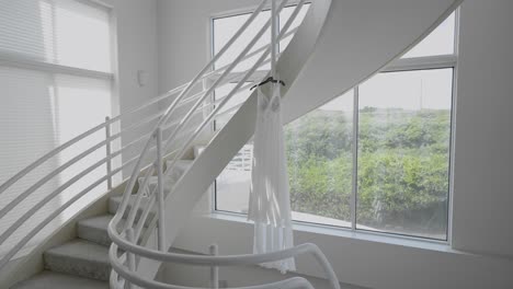 bride's wedding dress hanging beautifully in natural light