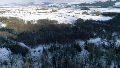 North-York-Moors-Snow-Scene-Drone-Flight,-From-Clay-Bank,-Urra-Moor-towards-Roseberry-Topping,-Winter-cold-and-moody-clouds,-Phantom-4-aerial,-Clip-1