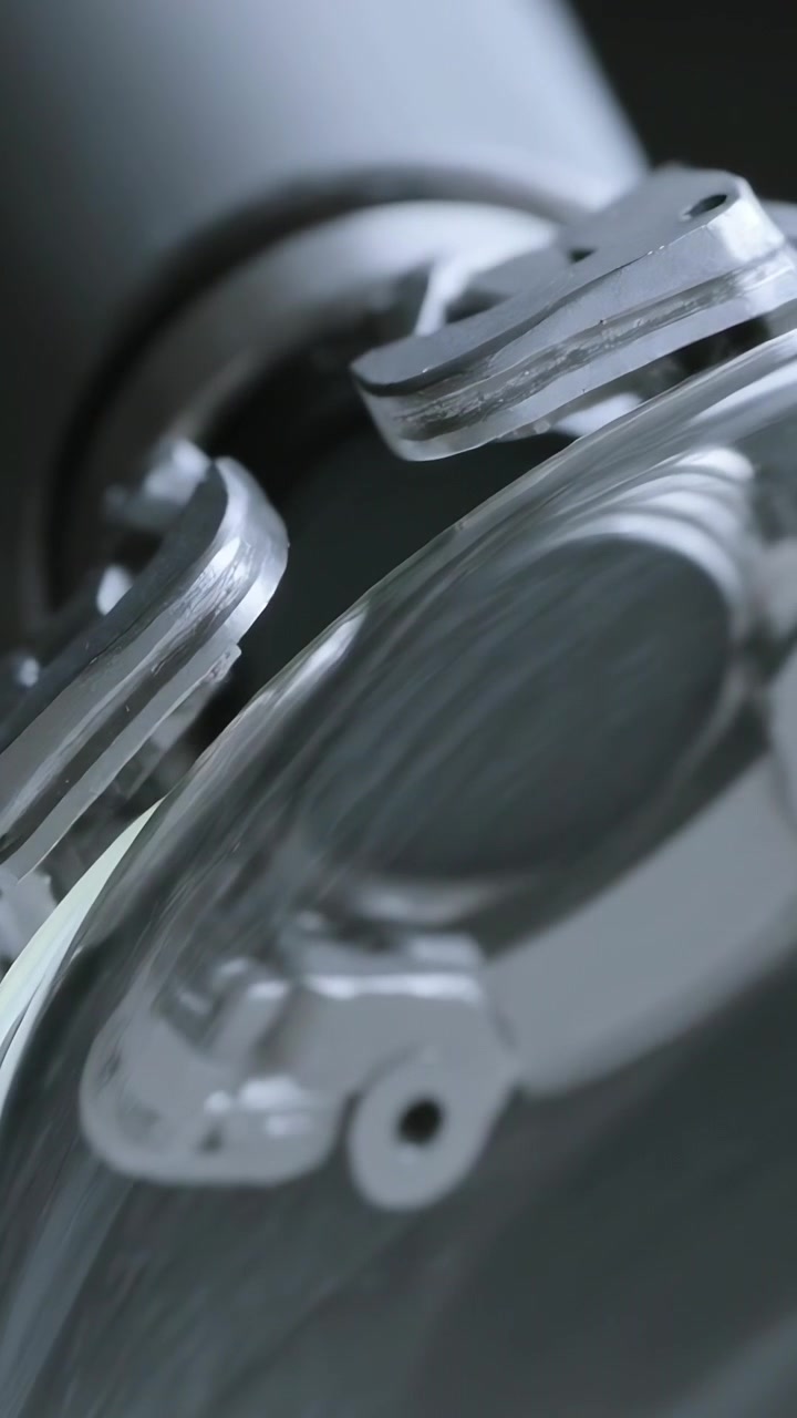 Vertical video: Tilting camera revealing clamp and dome in studio, shifting glare showing details