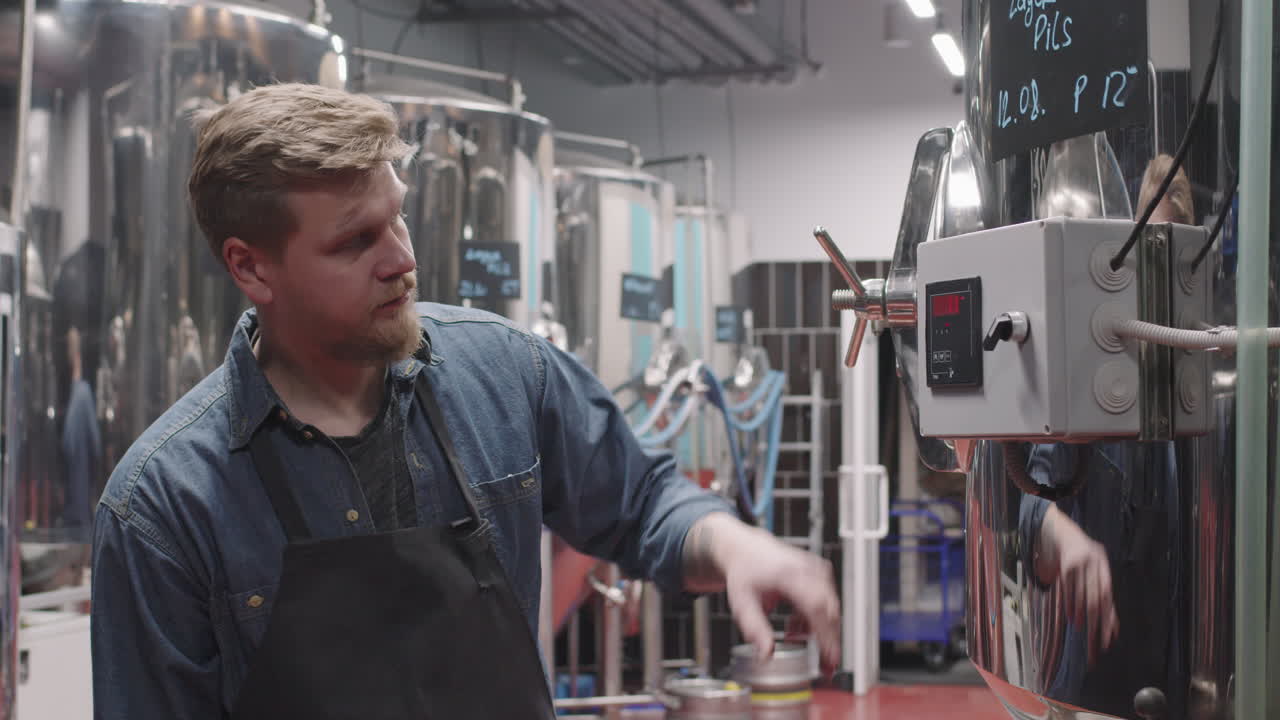 Brewery Worker Setting Parameters On Storage Tank