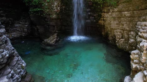 waterfall flowing and carving rocky formation with cold clean water in albania