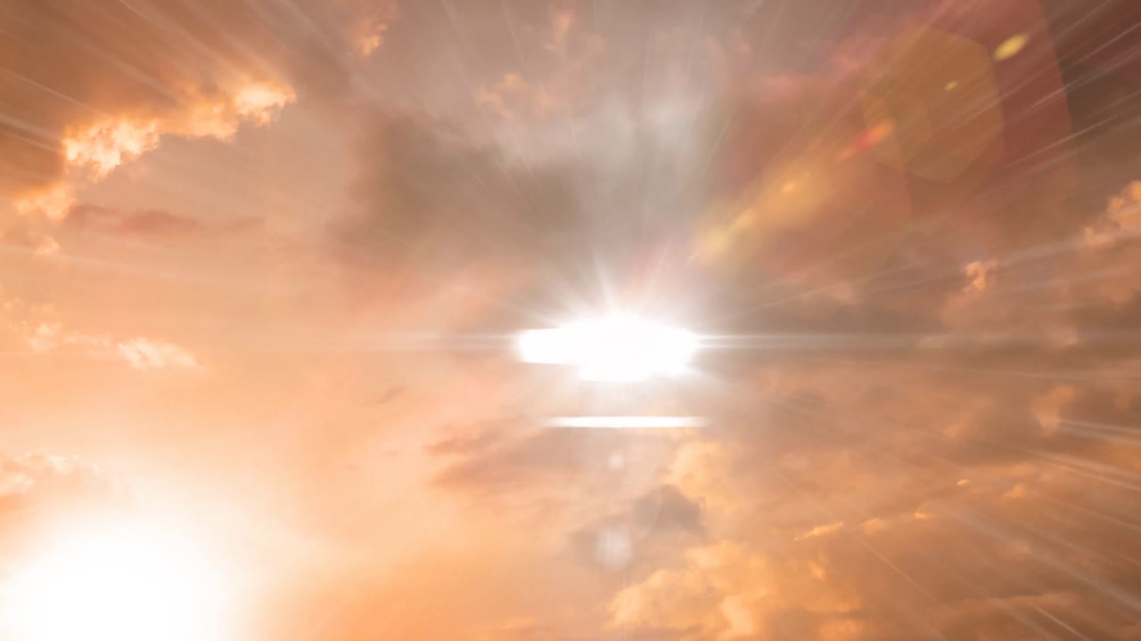 하늘의 오렌지색 구름에 대한 밝은 빛의 점의 디지털 애니메이션