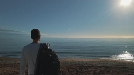 man staring at the beach, short dolly movement forward