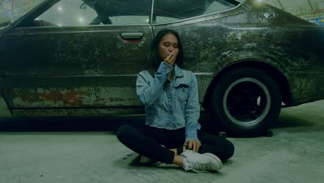woman smoking near an old car