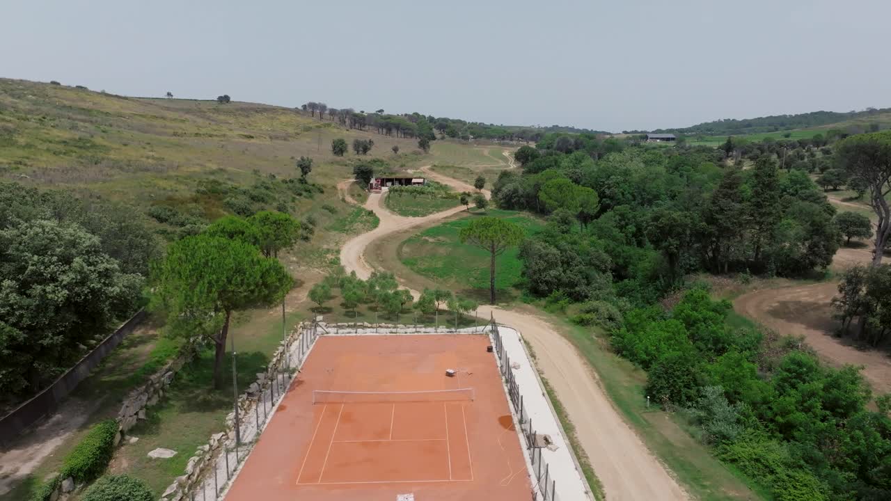 fotografía aérea de una lujosa cancha de tenis de arcilla naranja en el campo