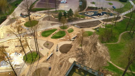 new park area in construction development in suburban neighbourhood outside city, aerial by drone