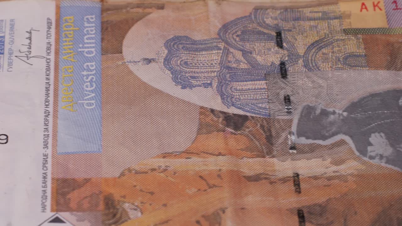 A heap of Serbian dinar paper currency, 1000, 2000 and 5000 dinars value. Serbian money as backgrounds. High quality 4k footage