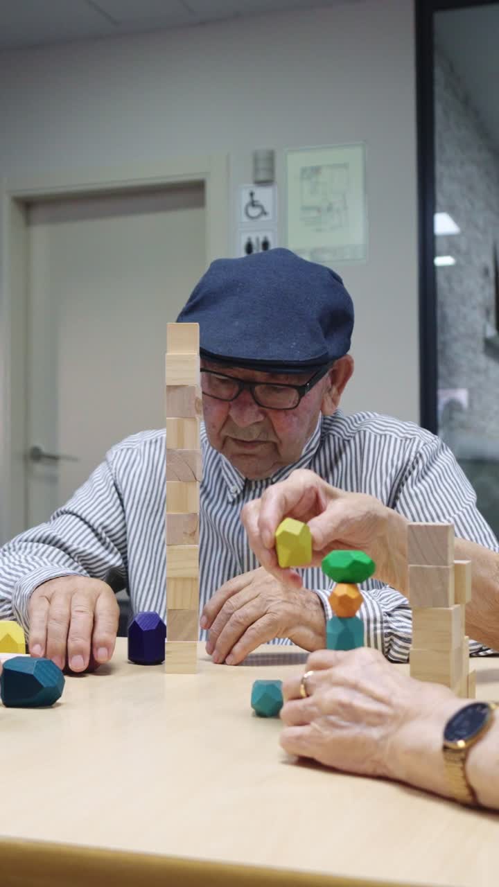 Elderly man playing a stacking game