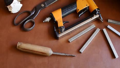 tilt up-upholstery tools on a vinyl sofa and ocher cushions