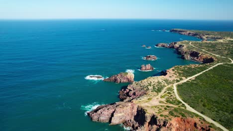 rugged coastline and blue sea with stacks. - aerial shot