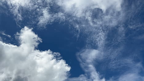 movement of white clouds against blue sky on sunny day