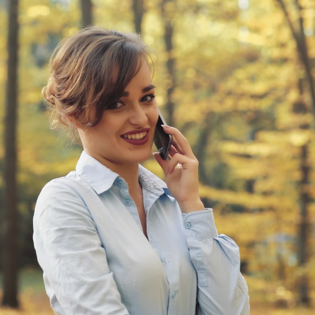 Woman with cellphone in park