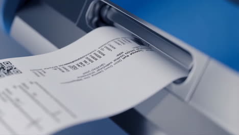 close-up of a paper receipt being dispensed from a machine or atm